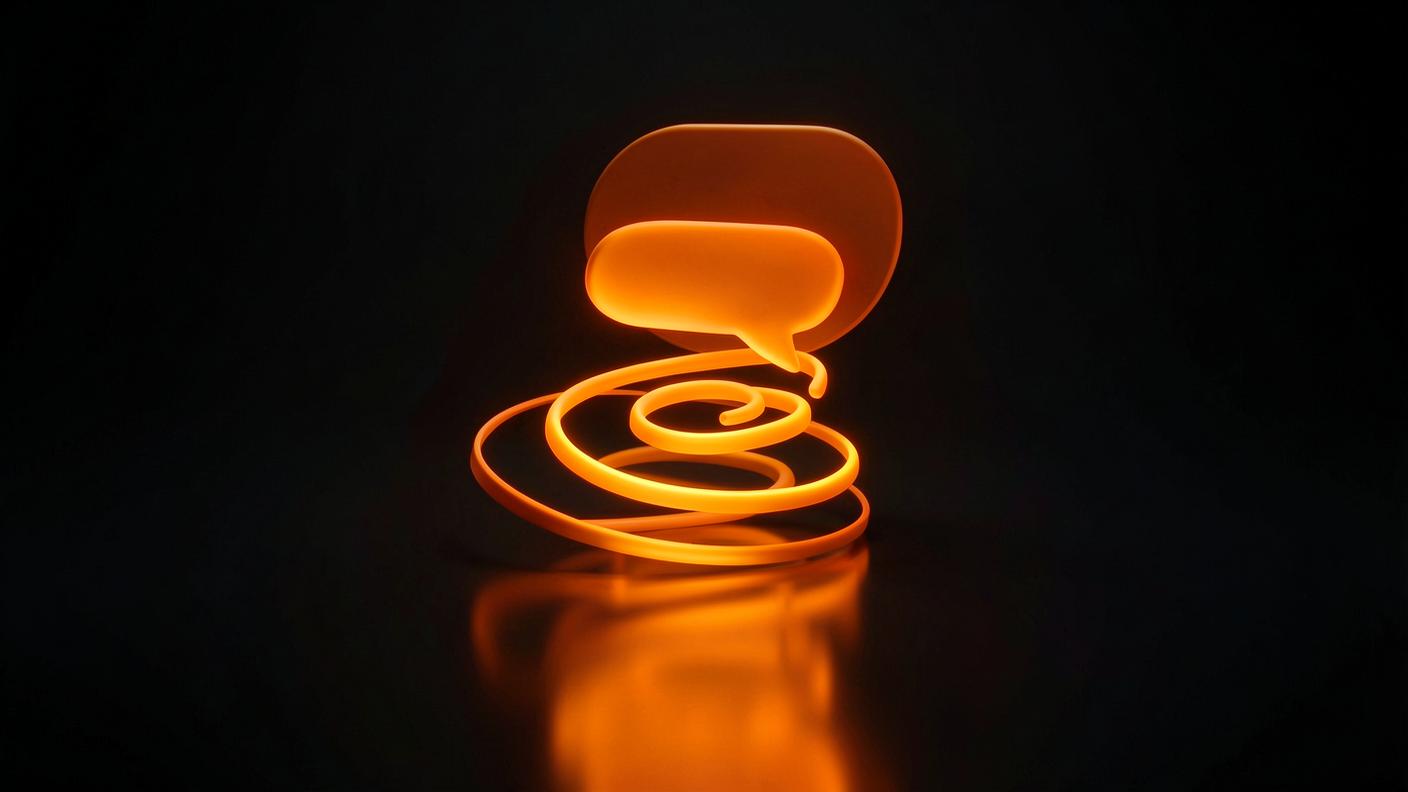 Editorial 3D render of glowing orange chat bubbles rising in a spiral above a dark reflective surface.